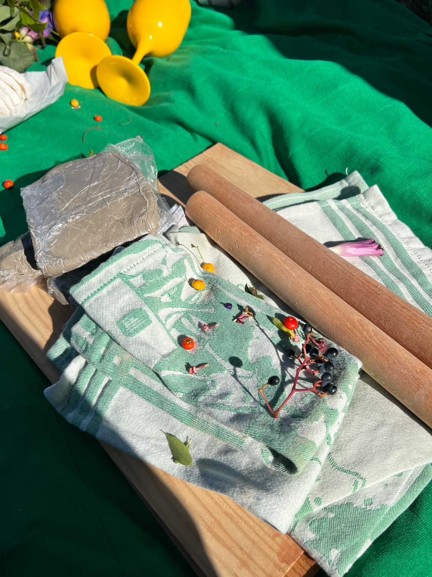 Green towel with nature-themed embroidery on a green surface