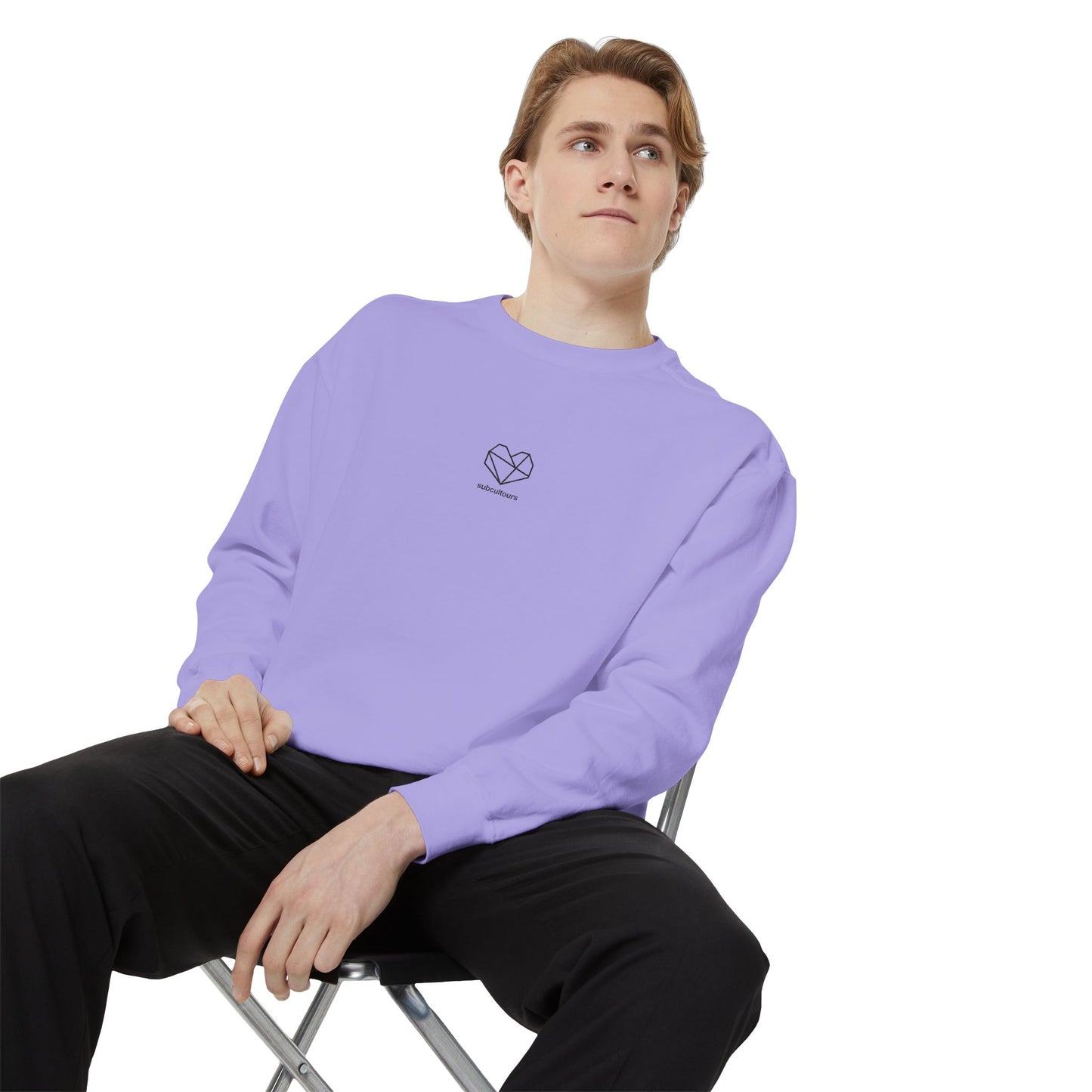 Person wearing a light purple sweatshirt with a logo, sitting on a chair against a white background