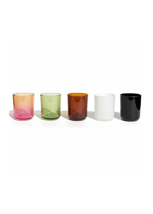 Set of five colorful glass tumblers on a white background