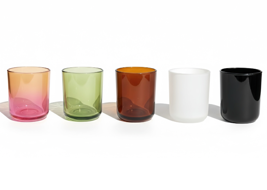 Set of five colored glass tumblers on a white background