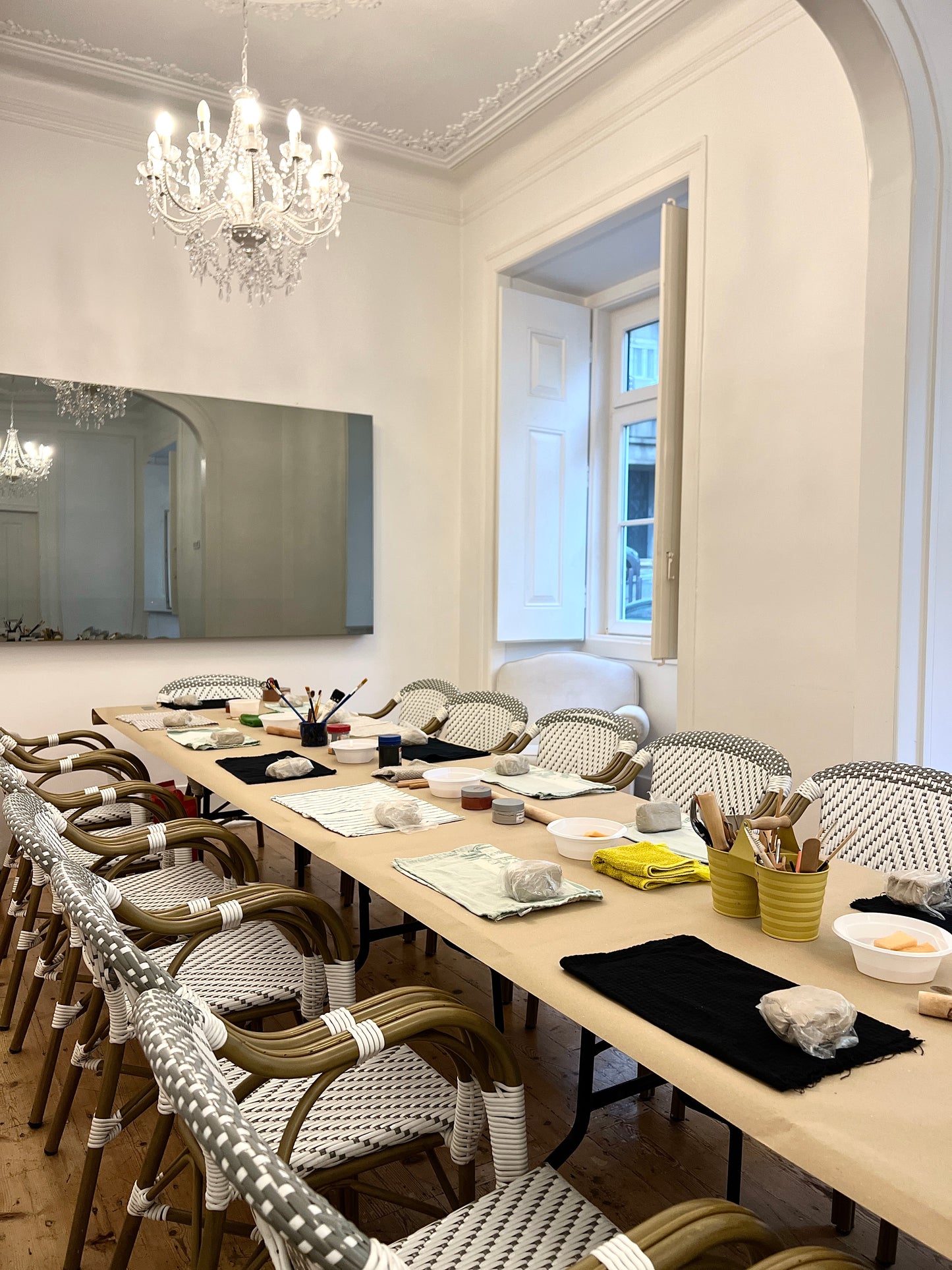 Dining room with long table set for a meal, chairs, and decorative elements.