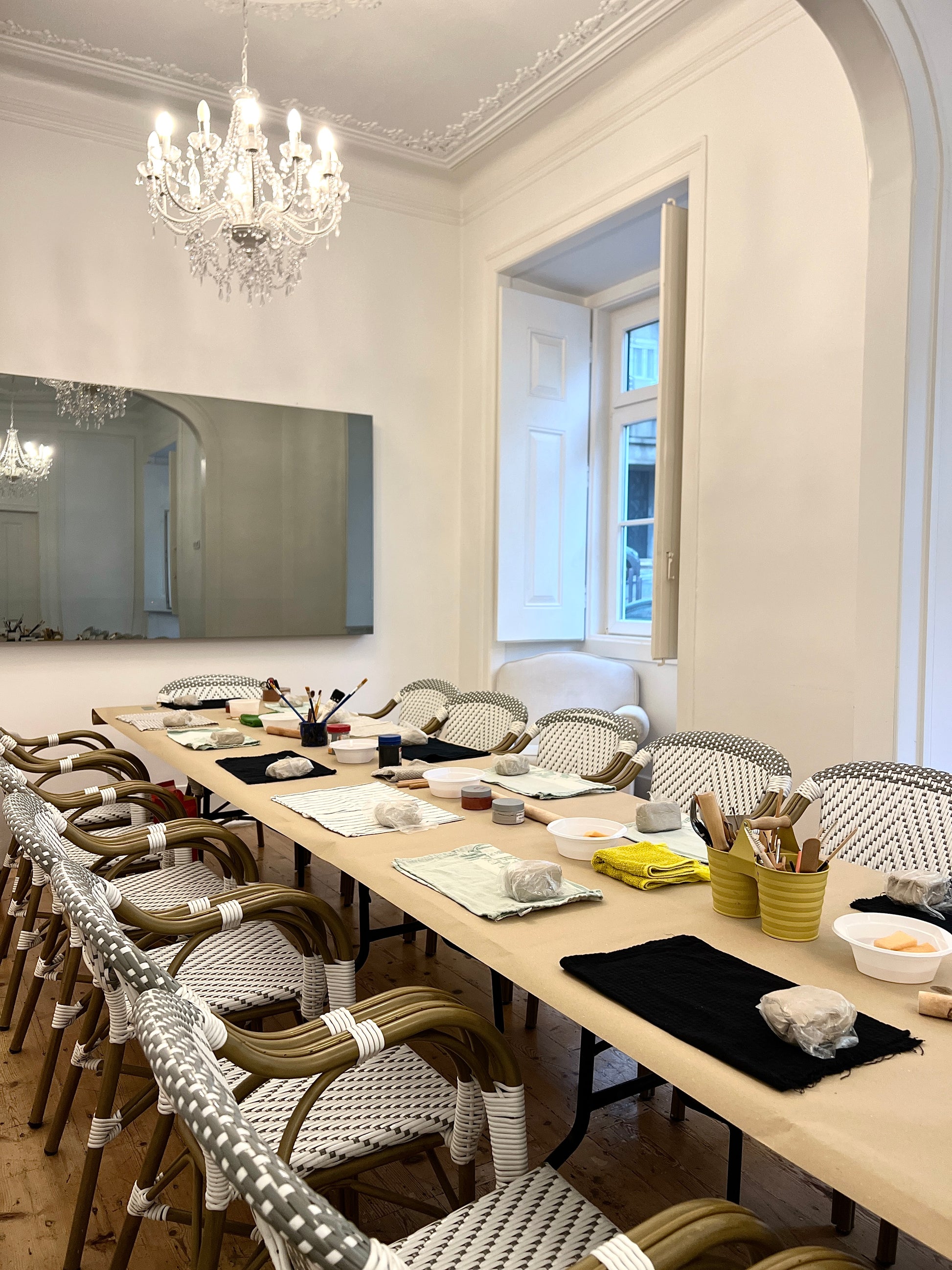 Dining room with long table set for a meal, chairs, and decorative elements.