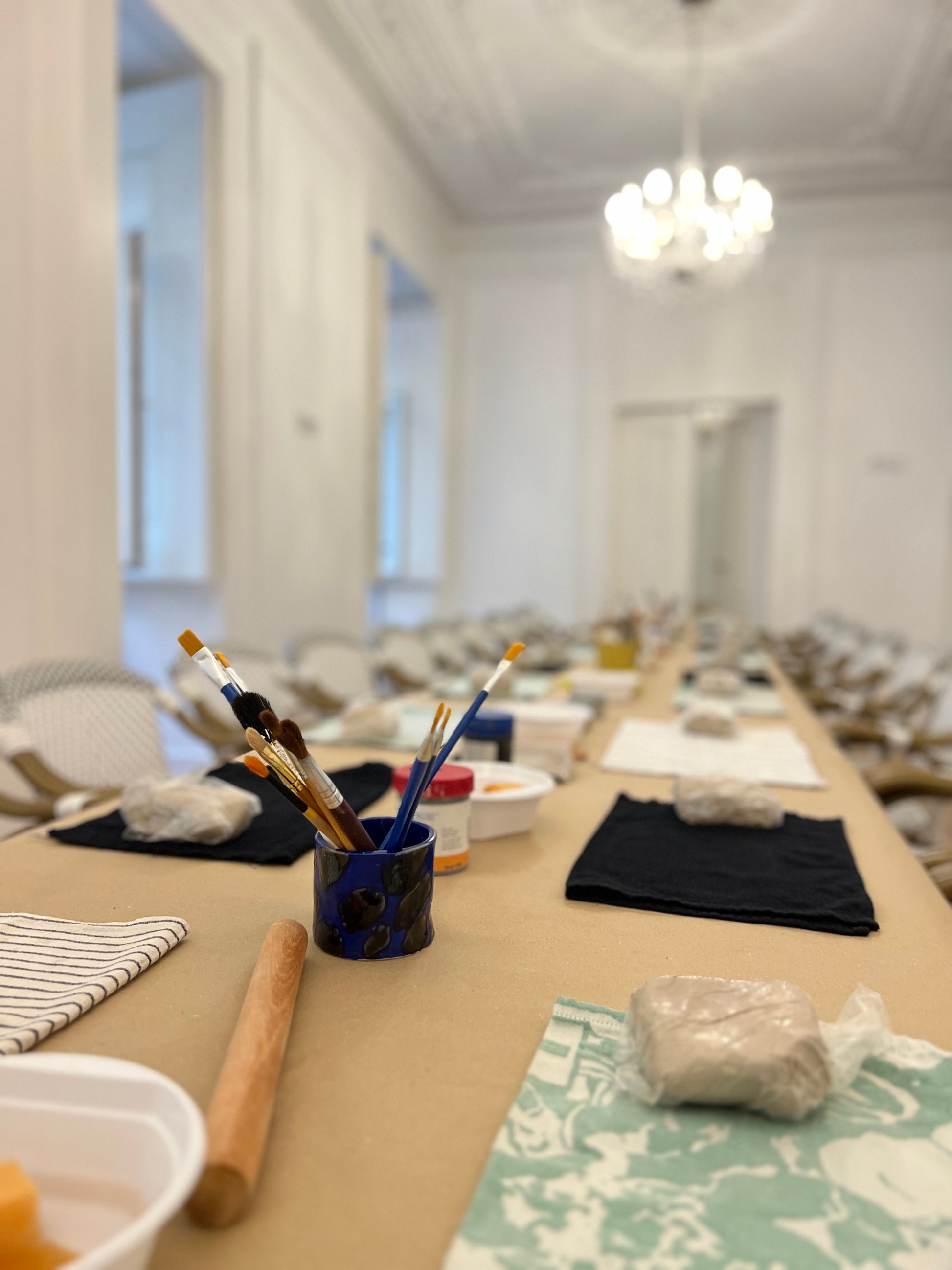 Art studio with painting materials on a table, blurred background