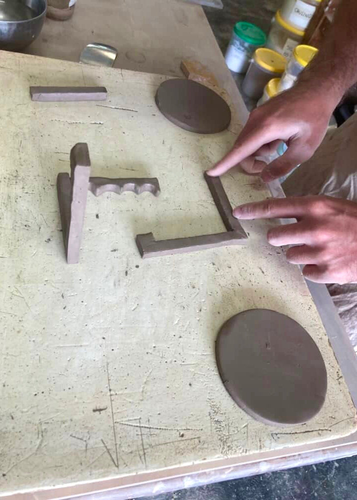 Person working with clay on a pottery wheel