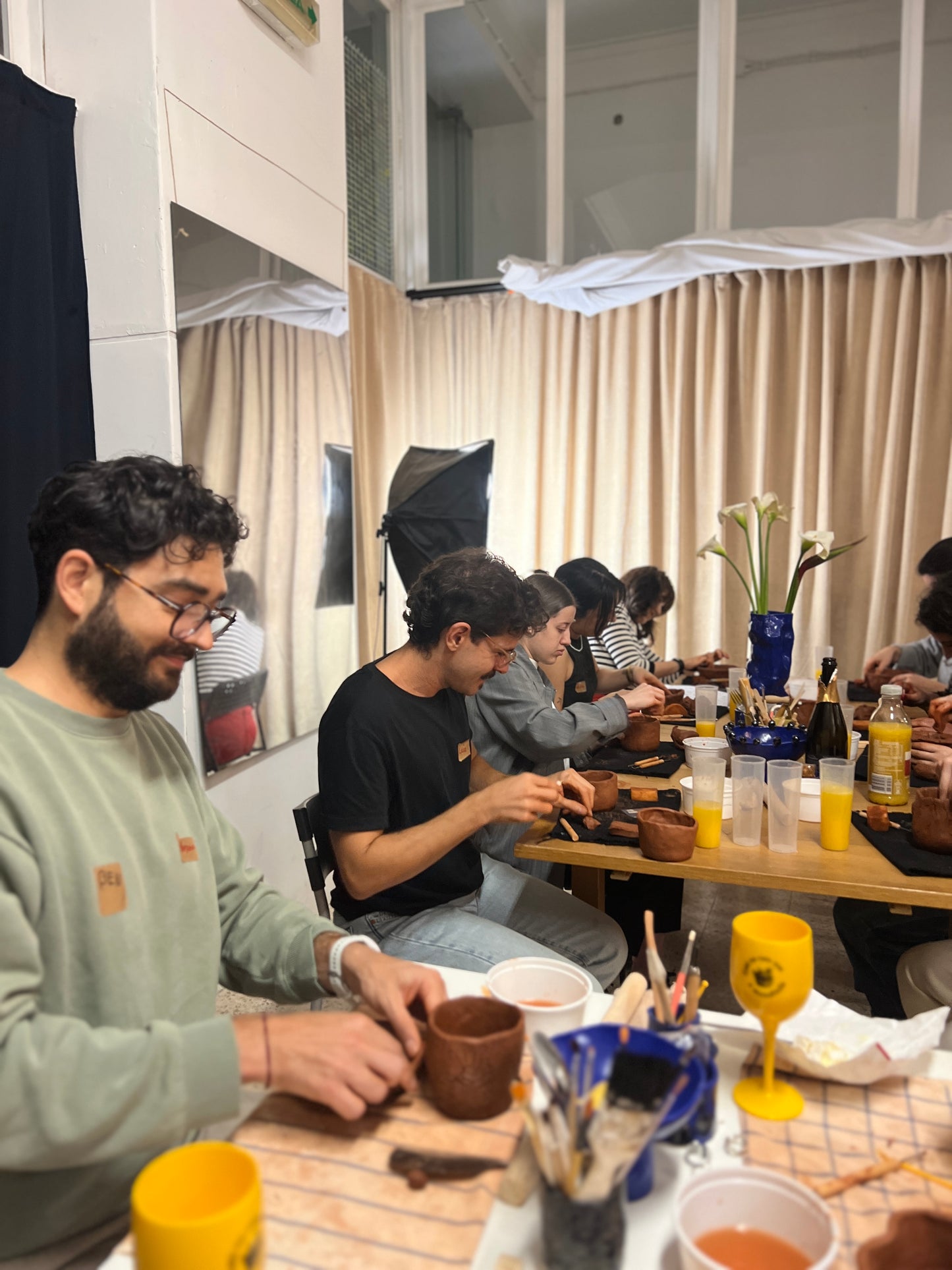 People sitting around a table in a casual setting, possibly a cafe or home.