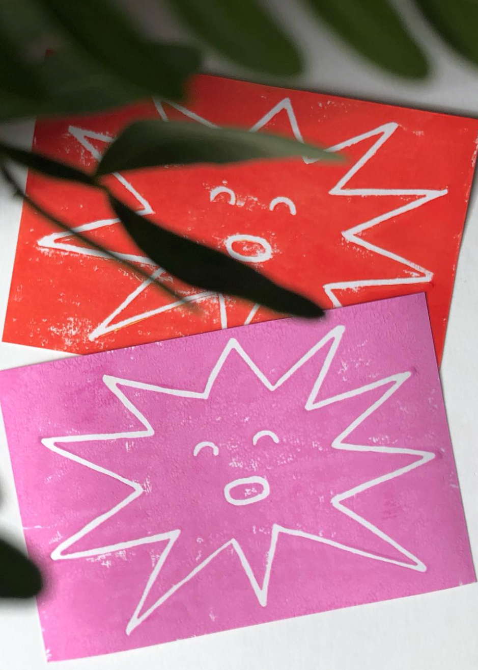 Two colorful greeting cards with star designs and smiley faces on a light background.