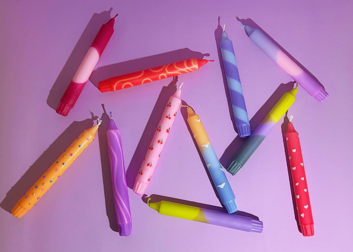 Hand holding a pink and red object with metal containers in the background