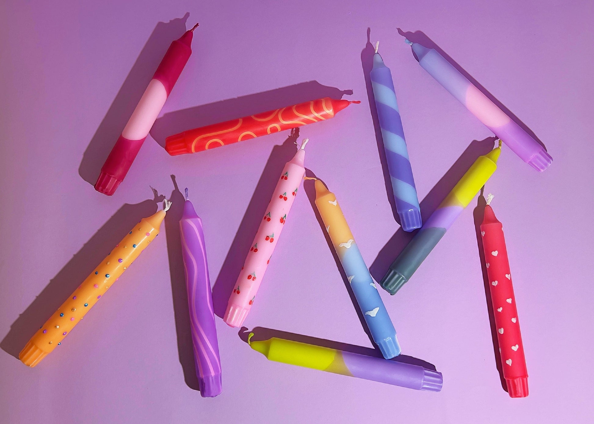 Hand holding a pink and red object with metal containers in the background