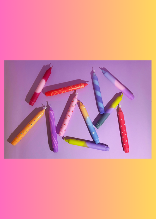 Colorful candles on a gradient background