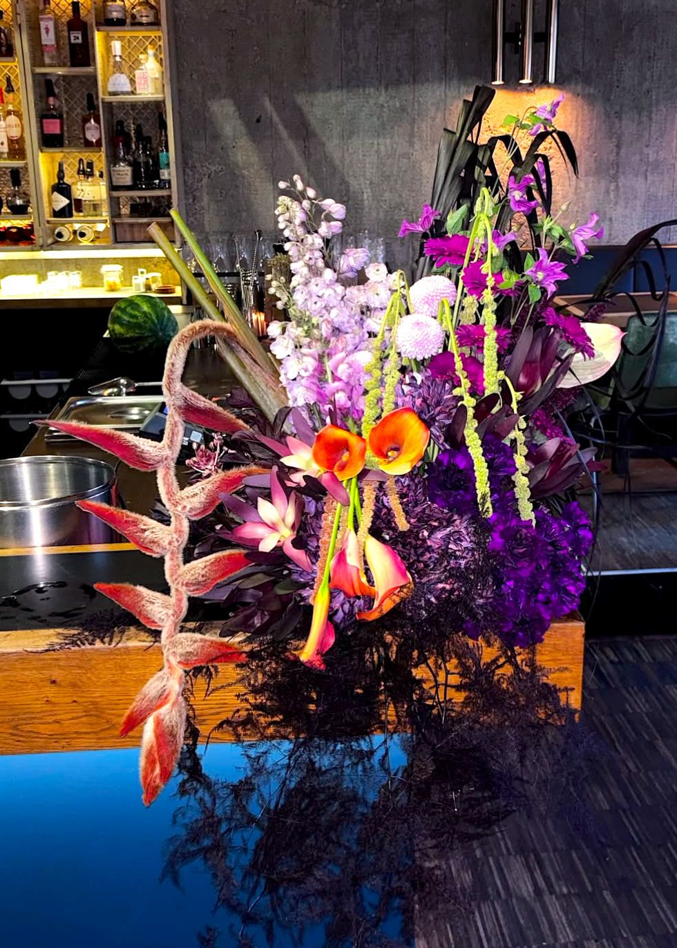 Colorful floral arrangement on a bar counter with a kitchen background