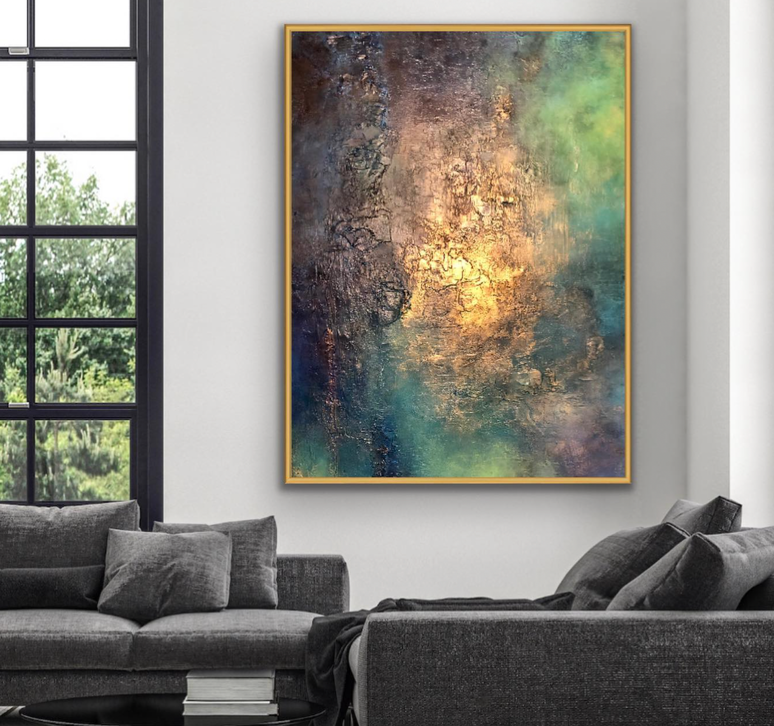 Abstract painting on a wall above a gray sofa in a room with large windows.
