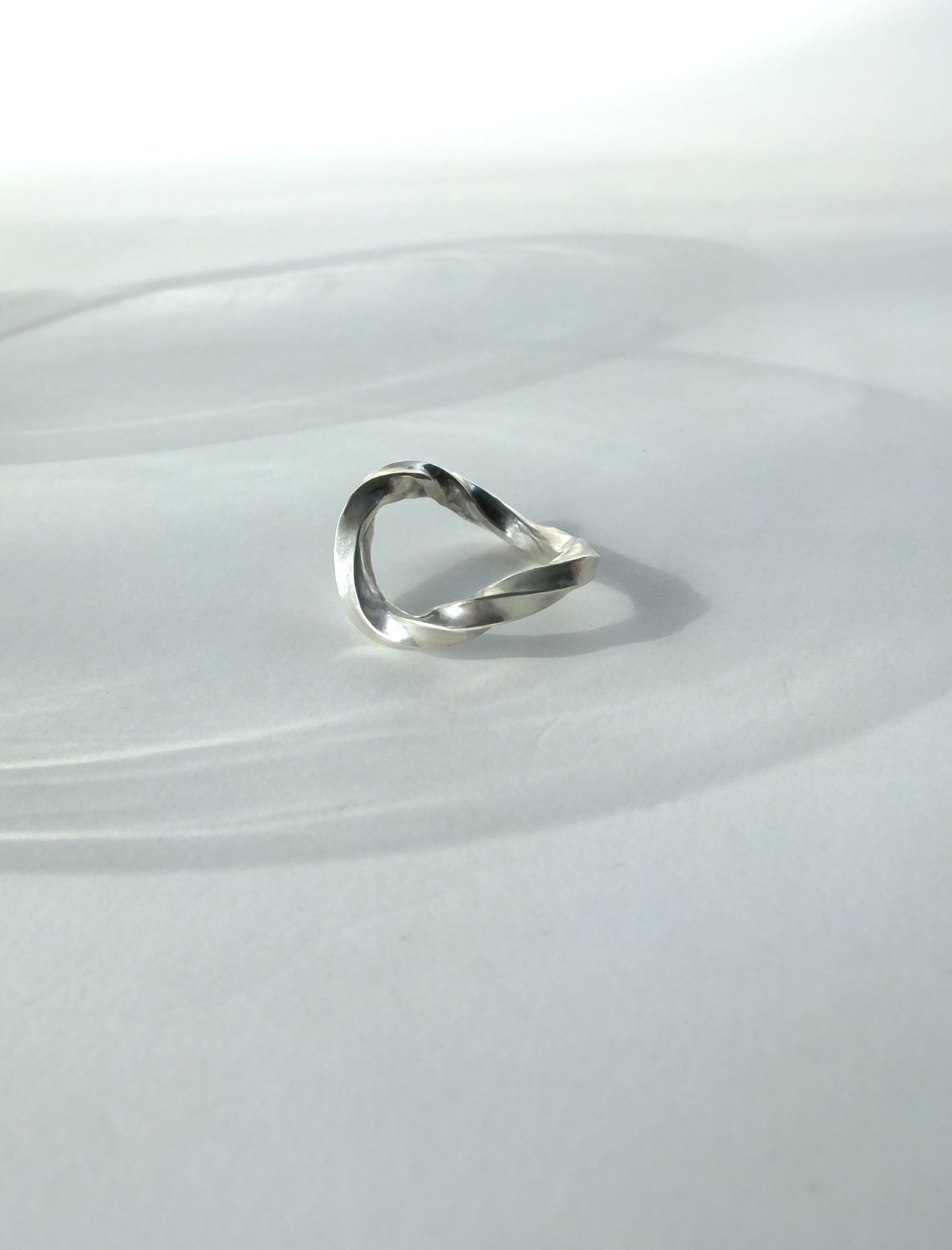 Silver ring on a white plate