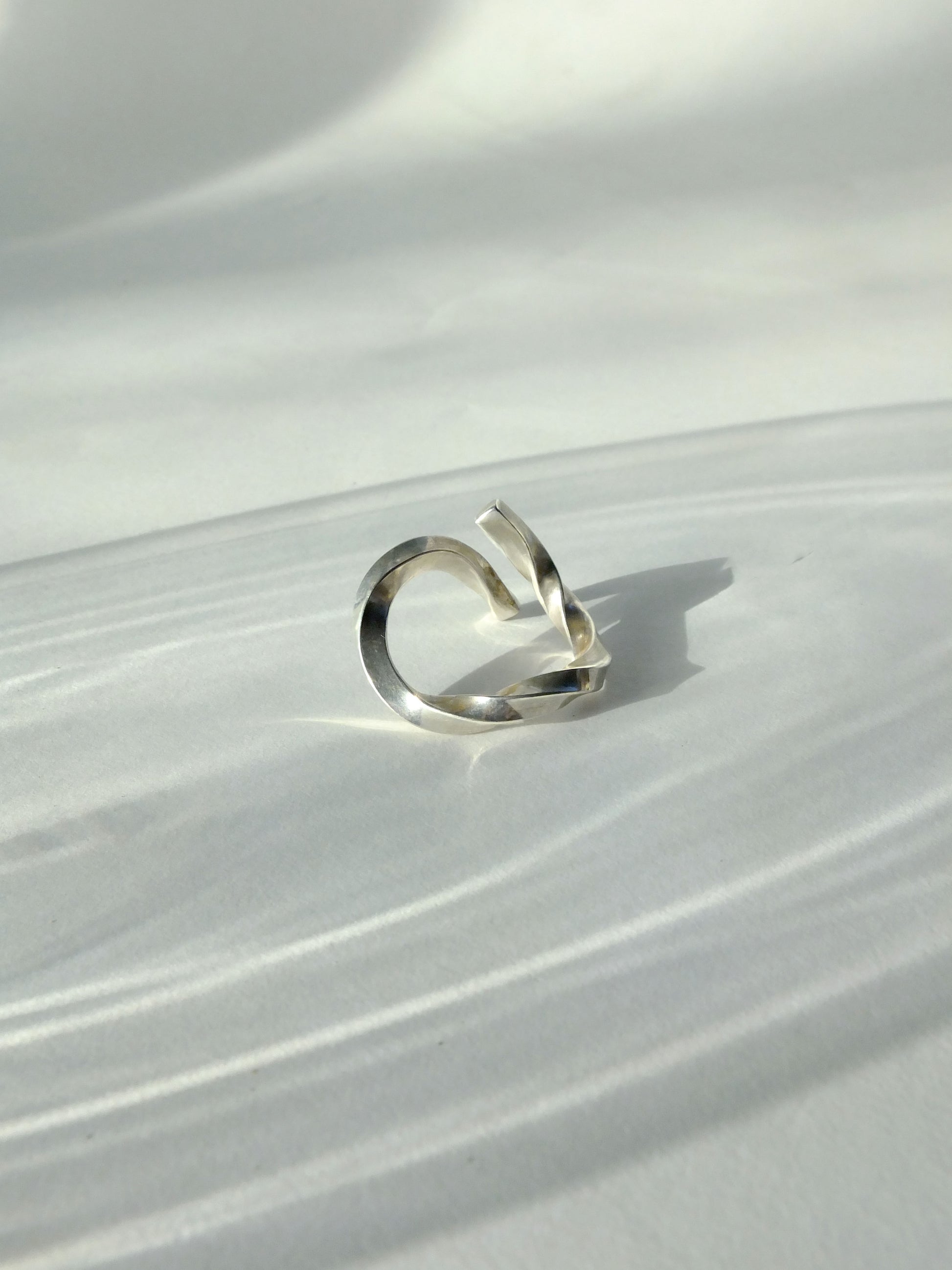 Silver ring on a textured white surface