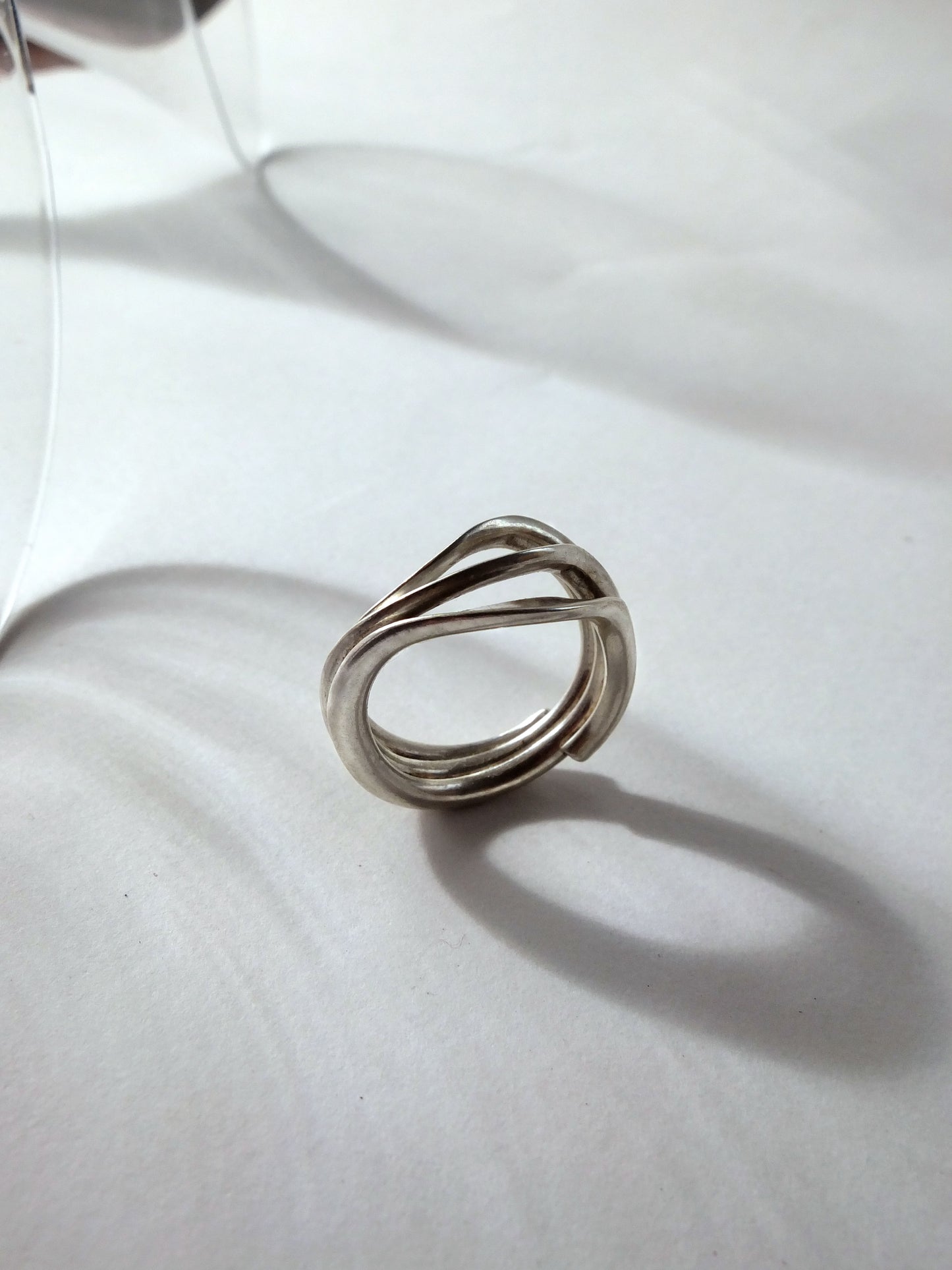 Silver ring on a white fabric surface