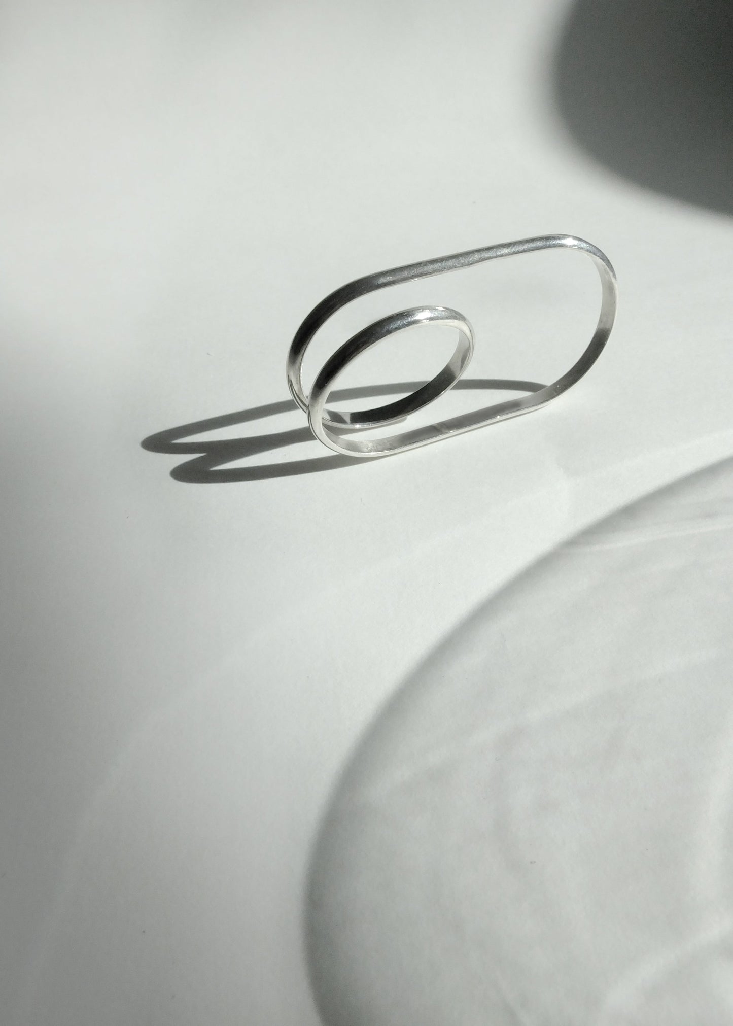 Silver ring on a light gray background