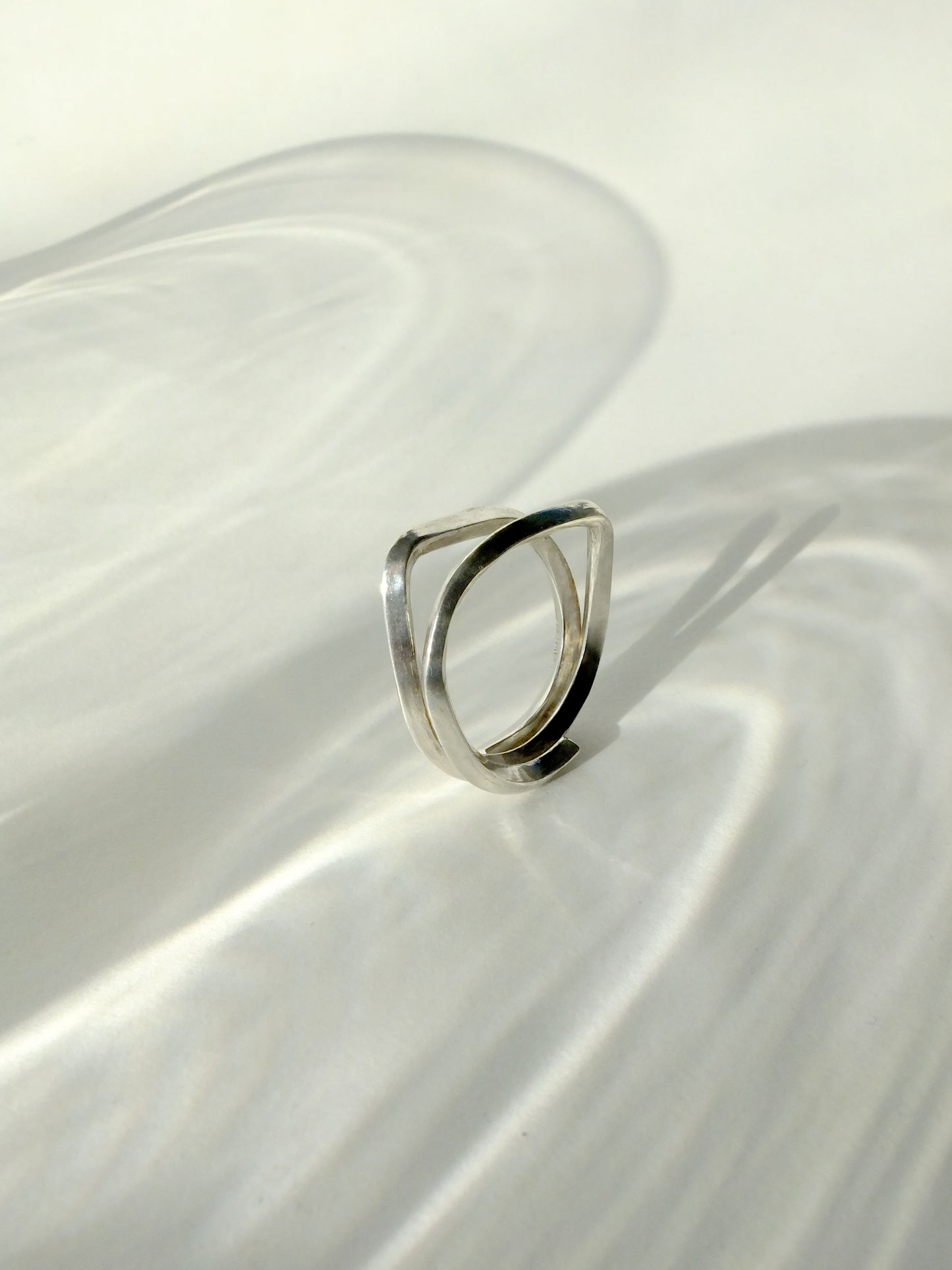 Silver ring on a white fabric surface