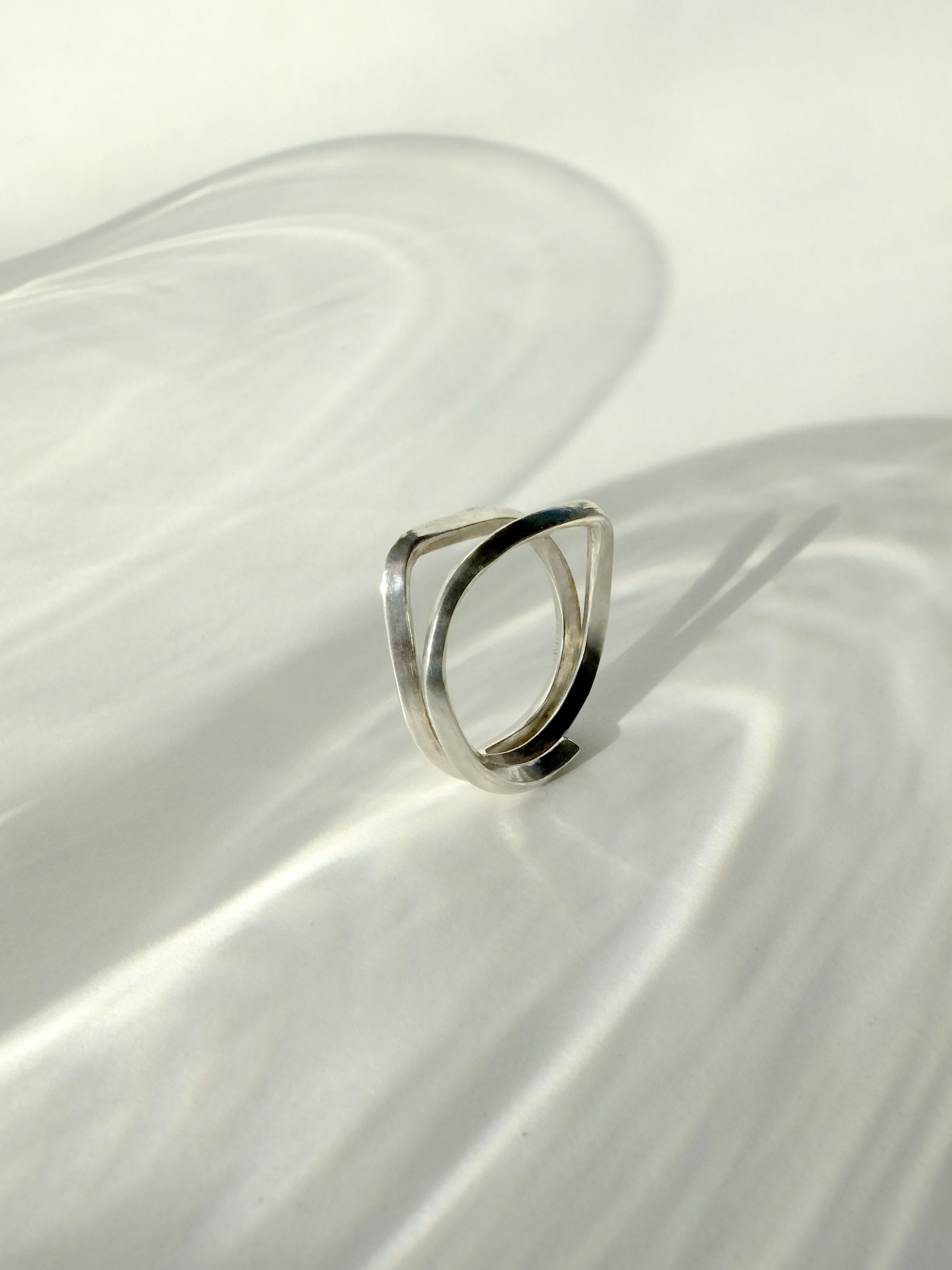 Silver ring on a white fabric surface