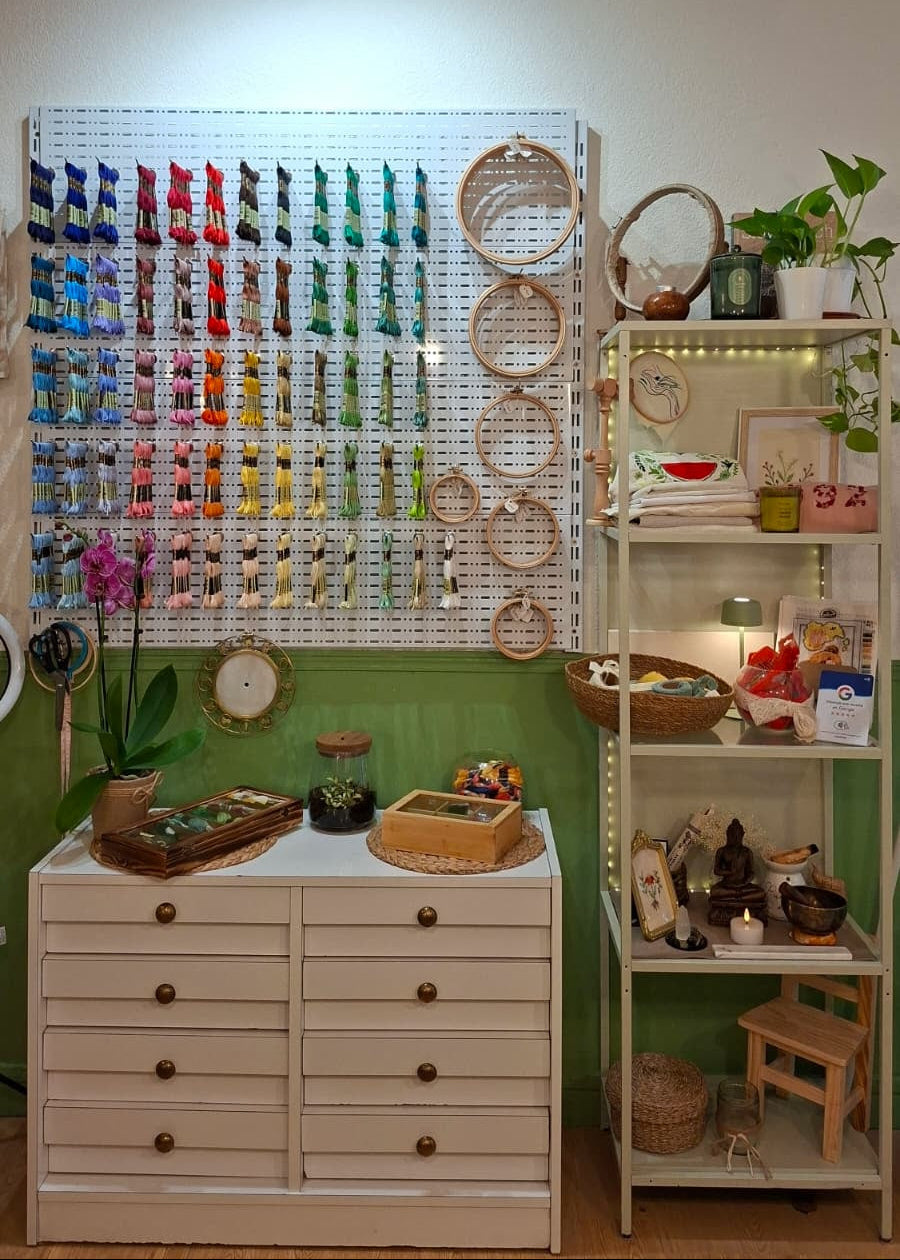 A styled interior room showing a large white pegboard wall filled with many colorful hair clips or hair accessories, alongside a cream cabinet, shelving, mirrors, and decor. This is not a clean isolated product shot, and the real room environment is clearly visible, so subject_type is Lifestyle rather than Product/Packaging.