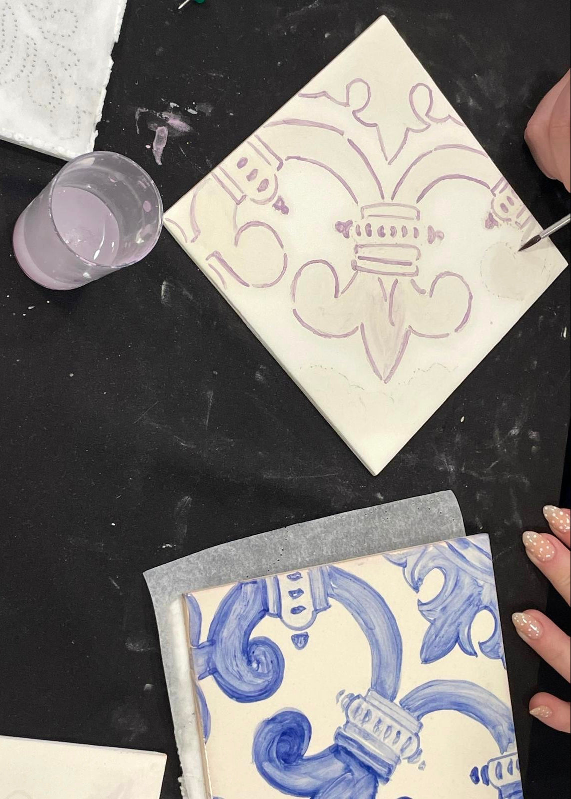 Decorative tiles with blue and white patterns on a black surface