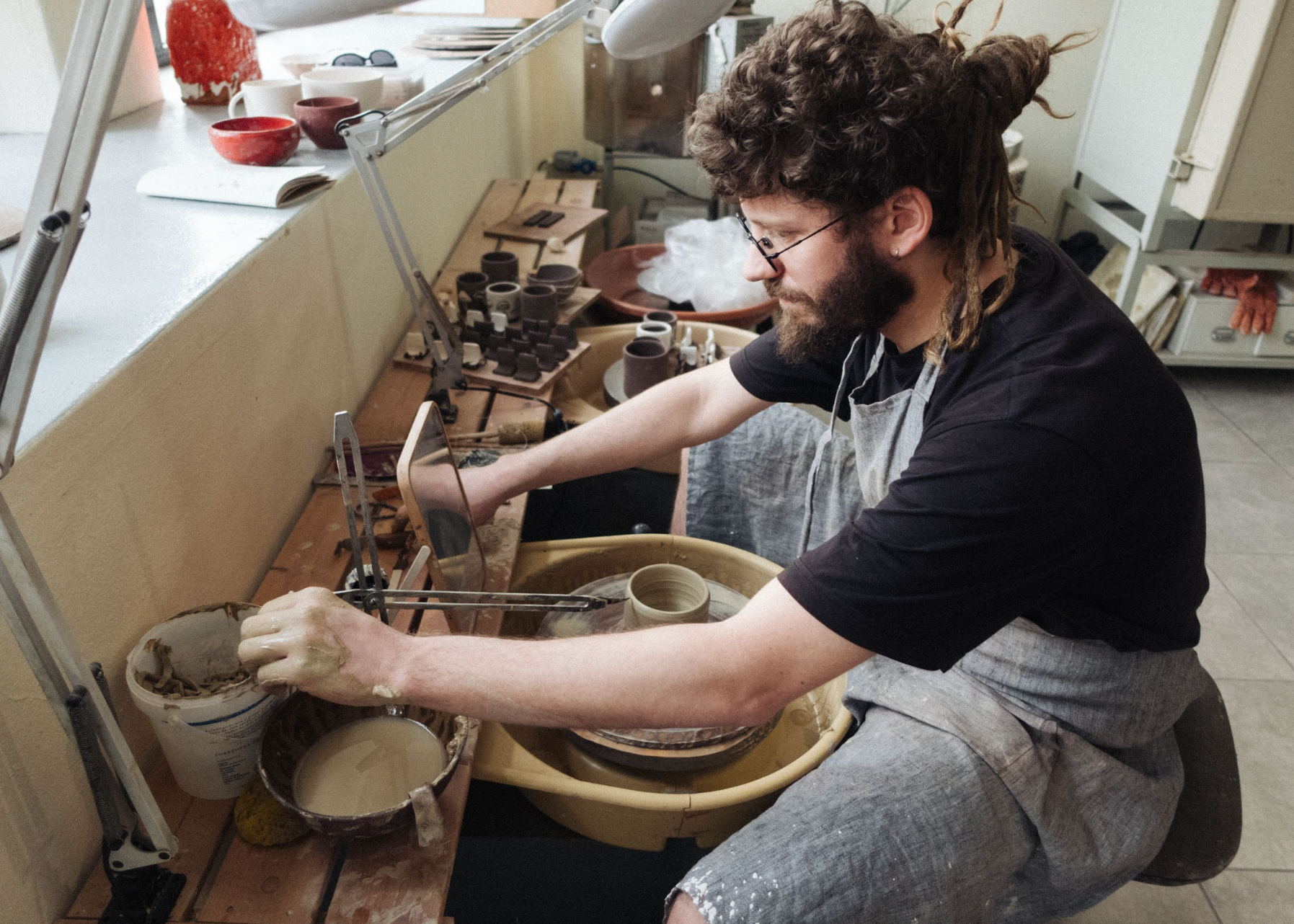 Person working with clay in a pottery studio