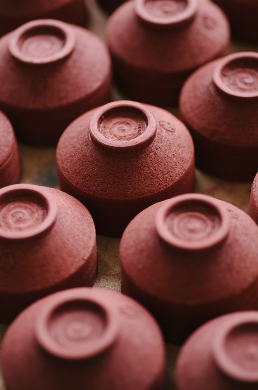 Close-up of terracotta pots with a brown background
