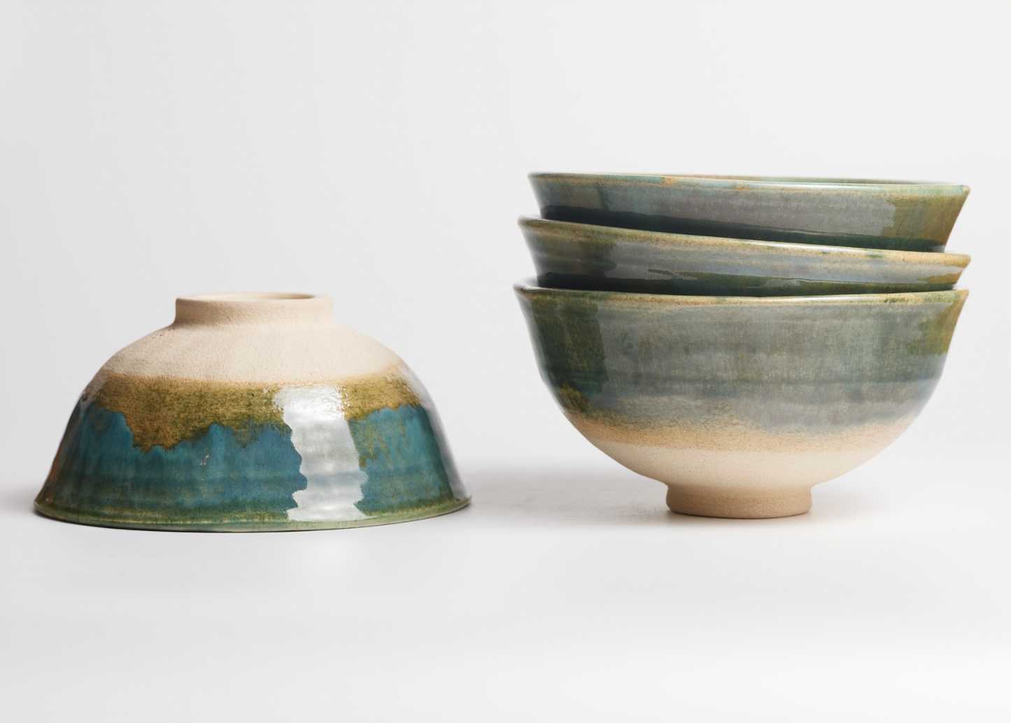Set of ceramic bowls with a gradient glaze on a white background