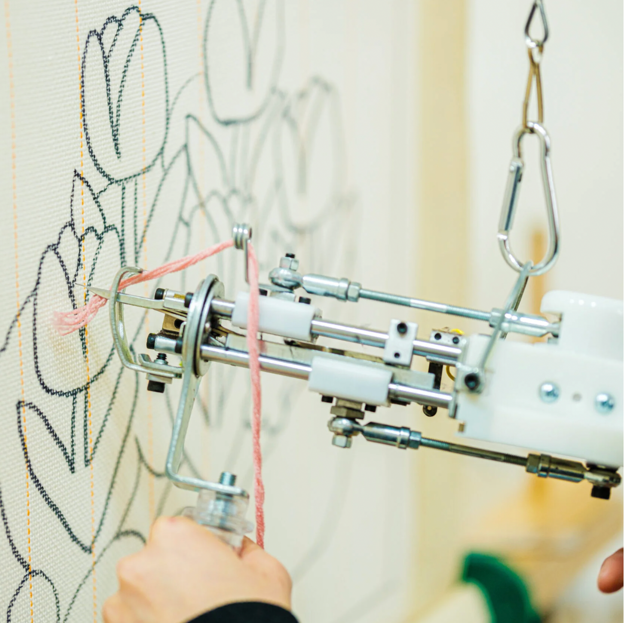 Embroidery machine stitching a design on fabric