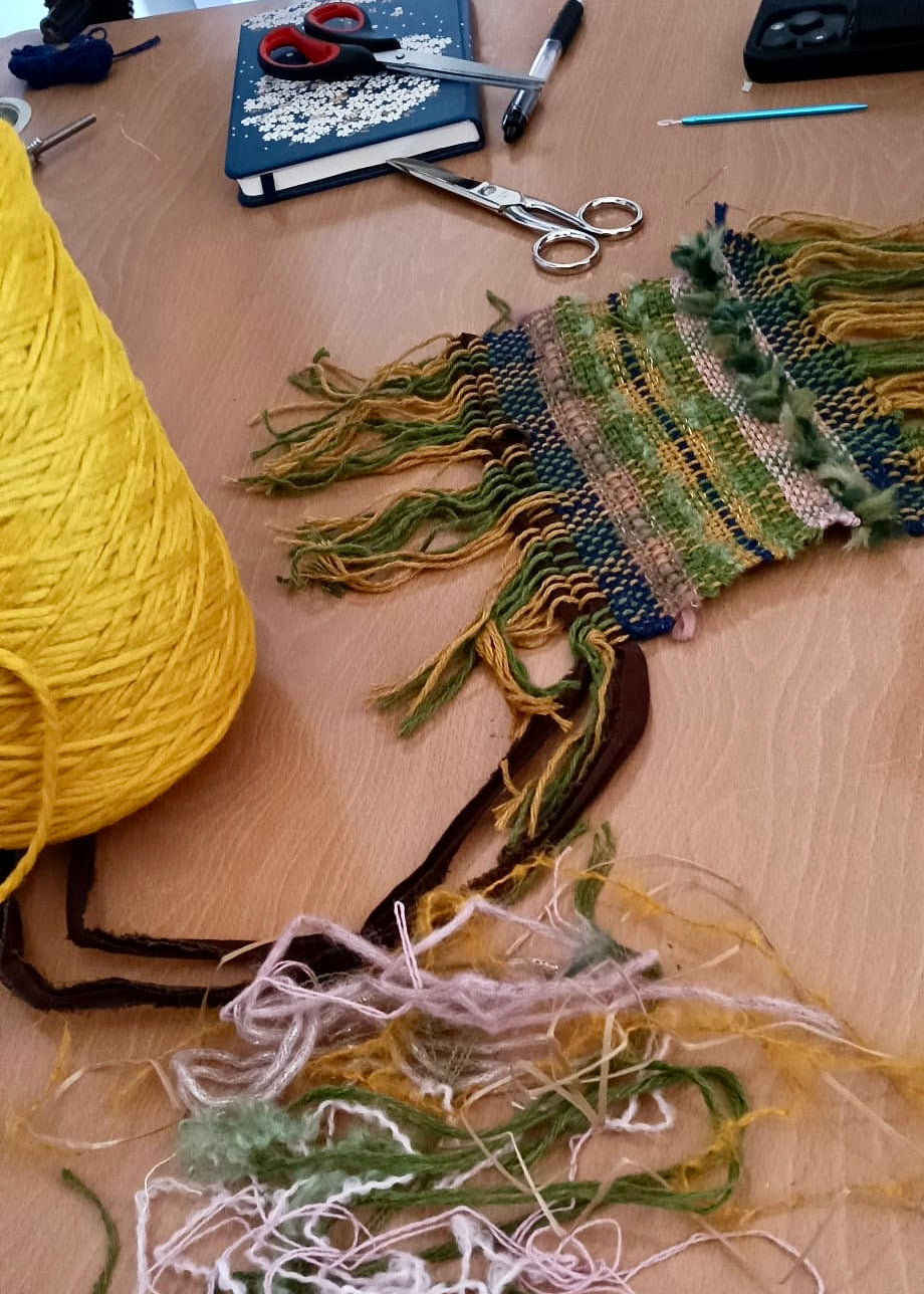 Yarn and weaving materials on a wooden table