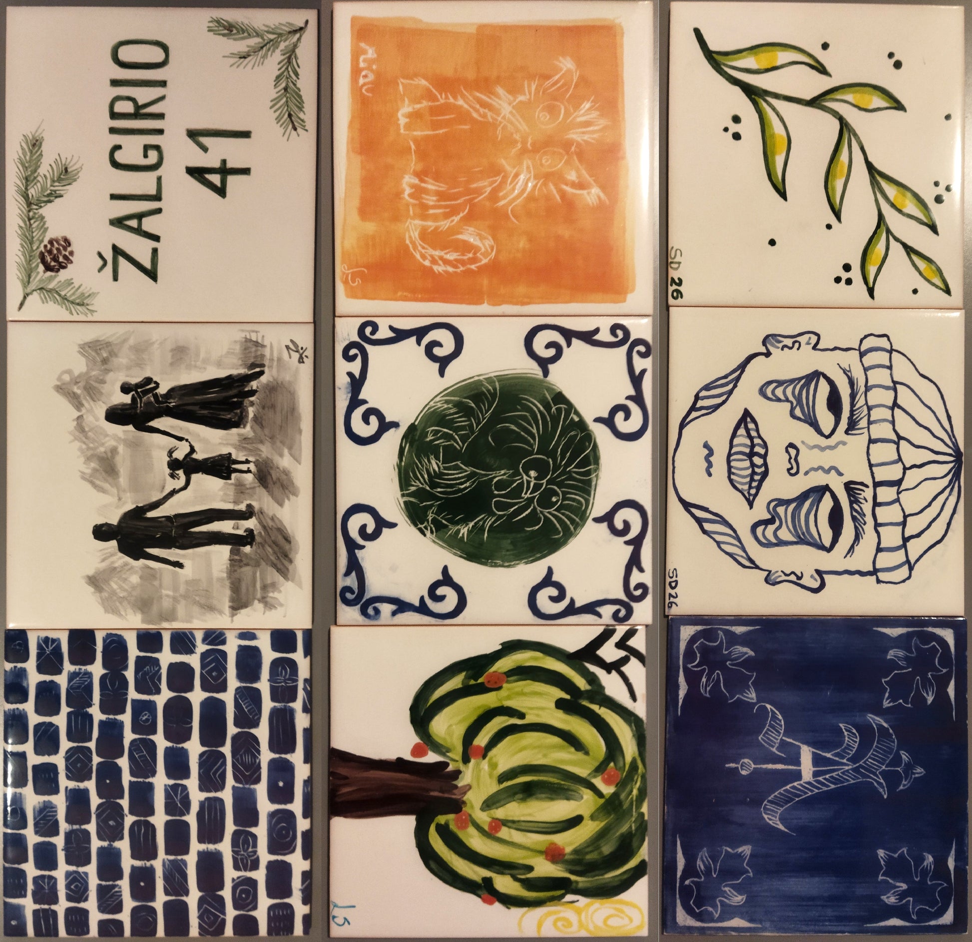 Collection of ceramic tiles with various artistic designs and patterns.