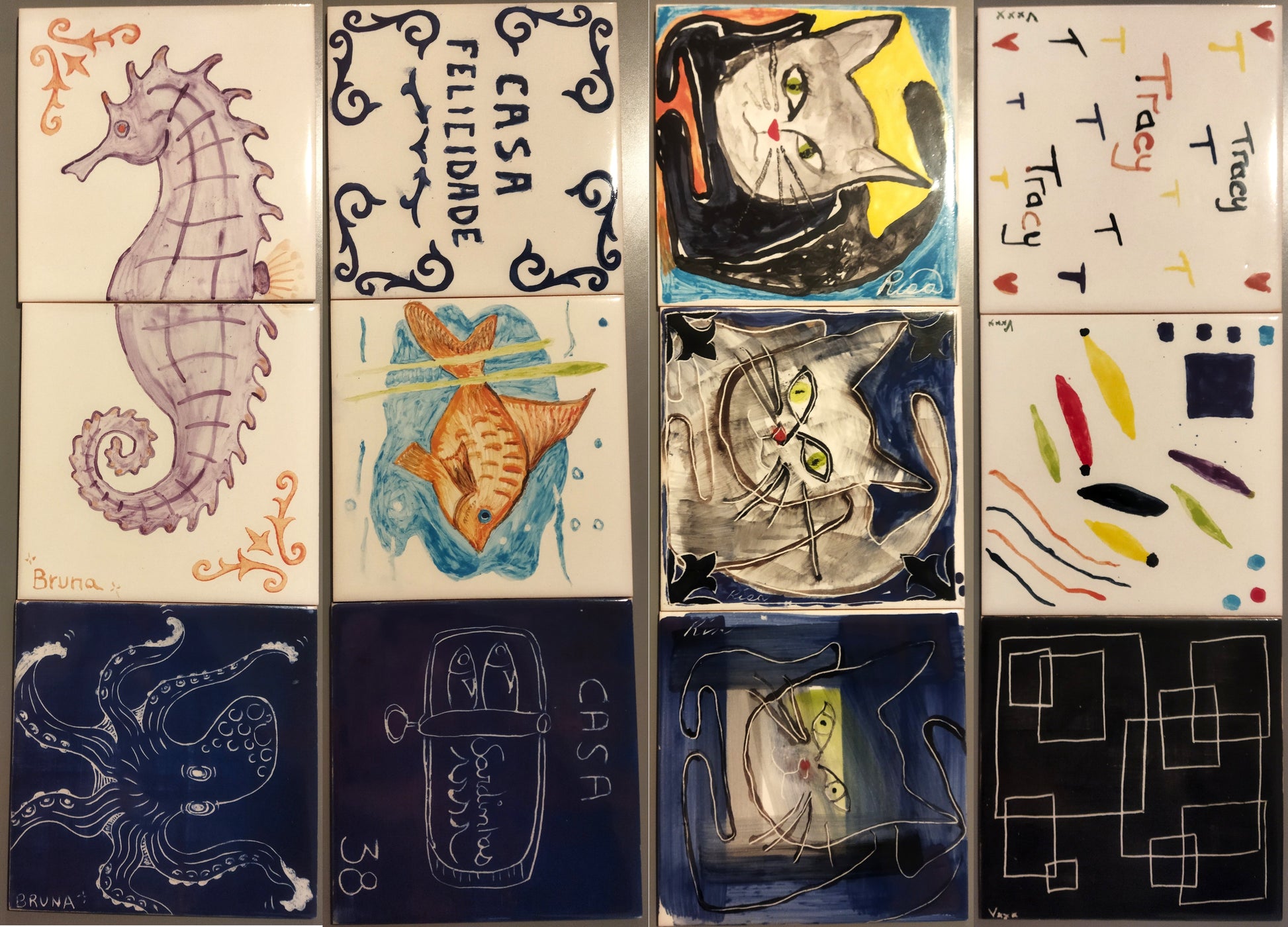 Collection of ceramic tiles with various designs including a seahorse, fish, cats, and abstract patterns.