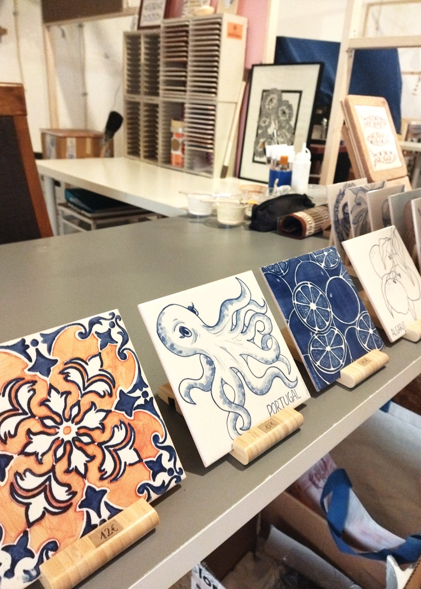 Table with various art prints and tools in a workshop setting