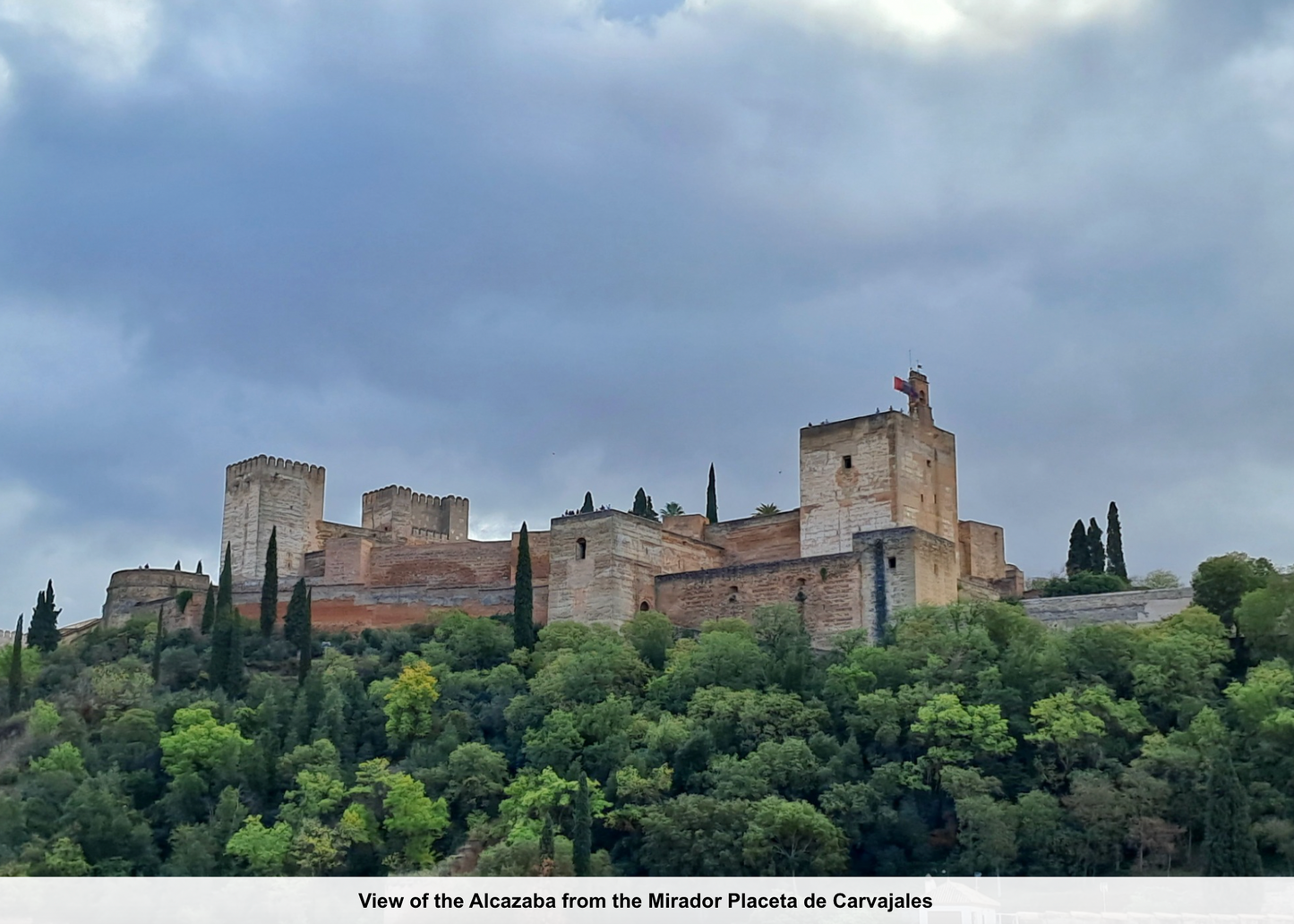 View of the Alcazaba from the Mirador Placeta de Carvajales with a castle on a hilltop.