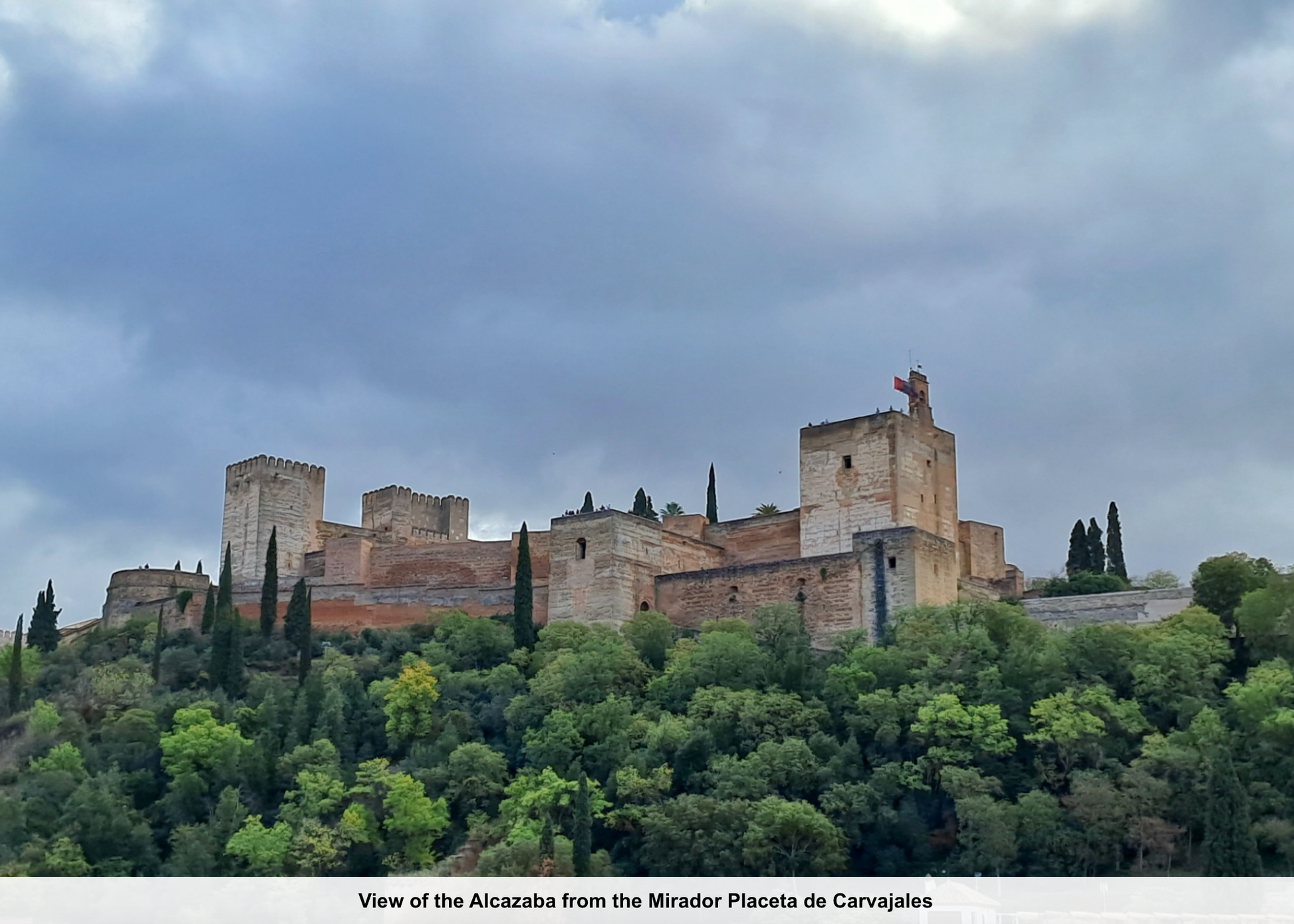 View of the Alcazaba from the Mirador Placeta de Carvajales with a castle on a hilltop.