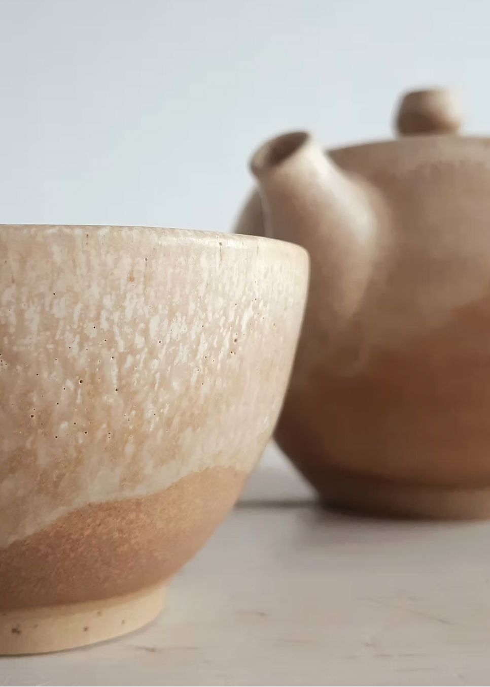 Two ceramic bowls with a textured surface on a light background