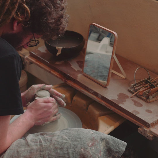 person working on a pottery wheel in porto portugal