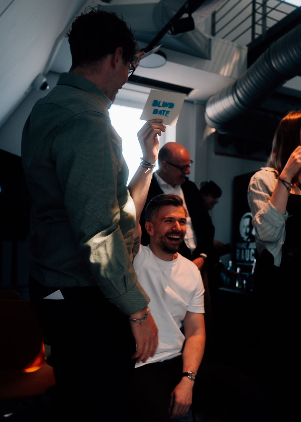 Group of people in a casual setting, possibly an office or studio.
