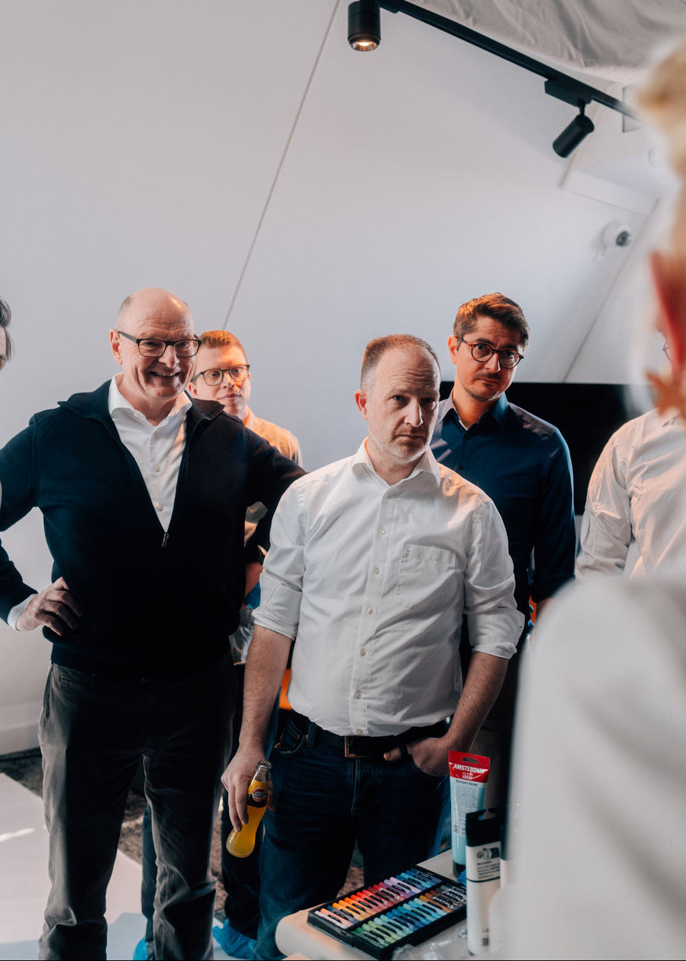 Group of men standing together in a modern indoor setting